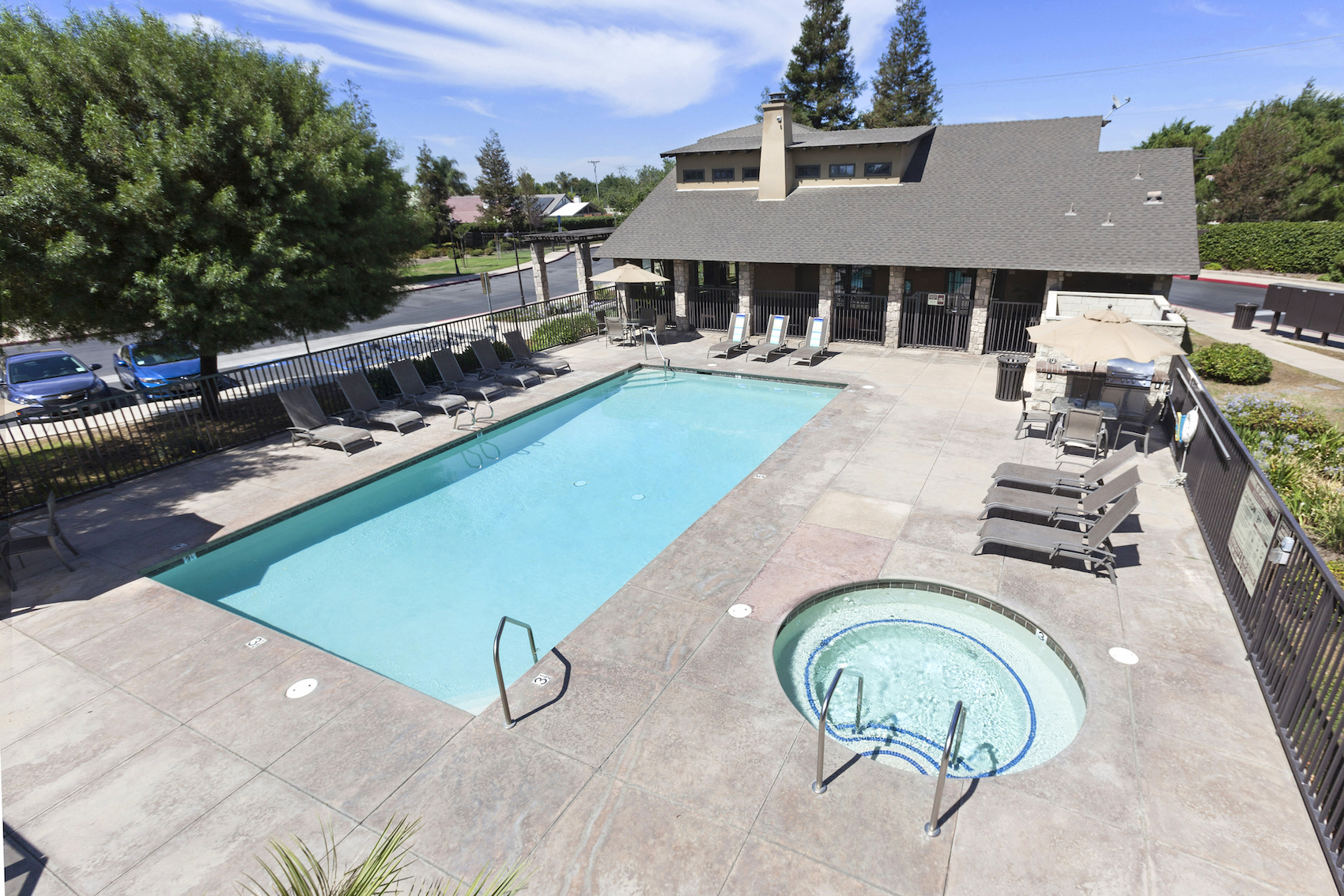 Polo Villas Pool and Heated Spa with Lounge Chairs, Tables, Umbrellas and BBQ  at Polo Villas, Bakersfield, CA